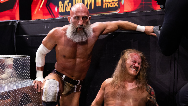 A wide-eyed Tommaso Ciampa kneels over a slightly bloodied Chris Jericho after a brawl on the June 20, 2026 edition of "AEW Collision."