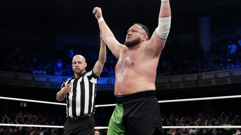 The referee holding up Joe's hand