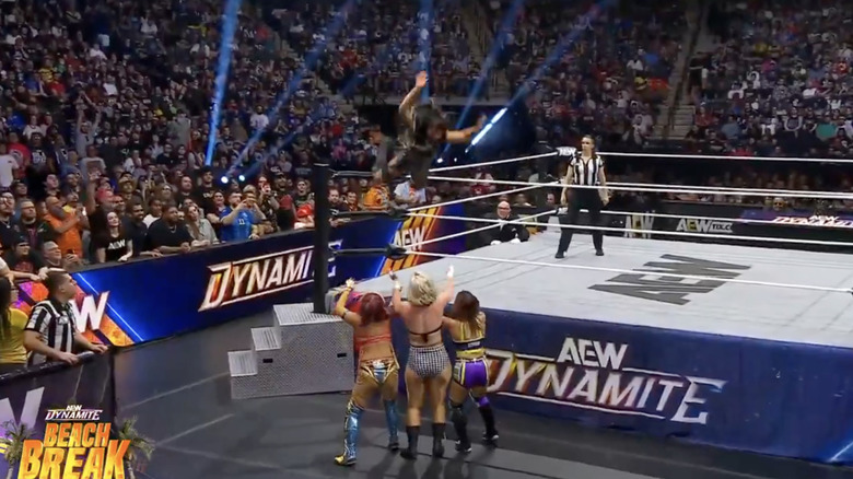 Blue flying with a crossbody to level Shirakawa, Storm, and AZM on the outside