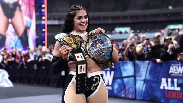 Persephone with both her TBS & CMLL World Women's Championship belts