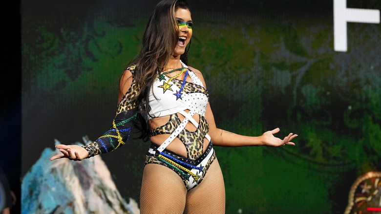 A newly-returned Tay Melo poses in her wrestling gear on the stage at "AEW Collision: Fyter Fest."