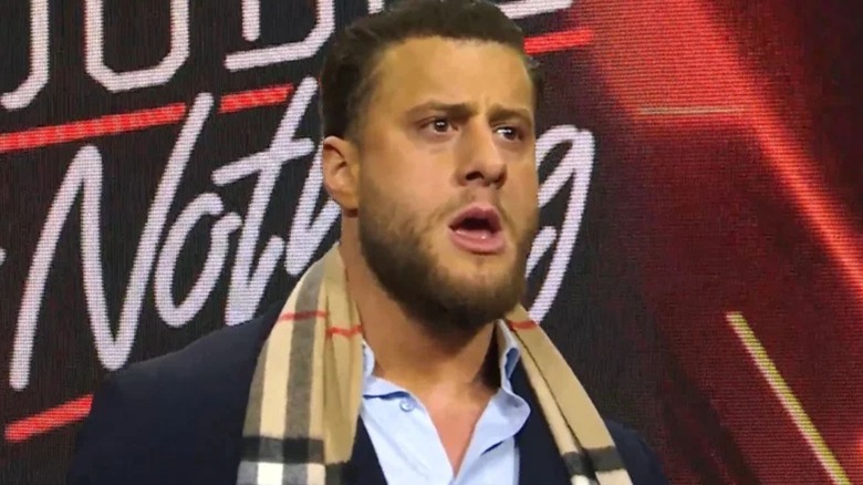 MJF stares in disbelief from the stage to the ring at AEW World Champion Darby Allin, after Allin pitched him a hair-vs-title match at Double or Nothing.
