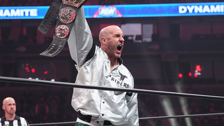Claudio Castagnoli holding up the ROH Title 