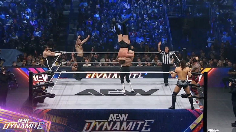 Castagnoli about to land a delayed vertical suplex on Takeshita as everyone else stands on the apron