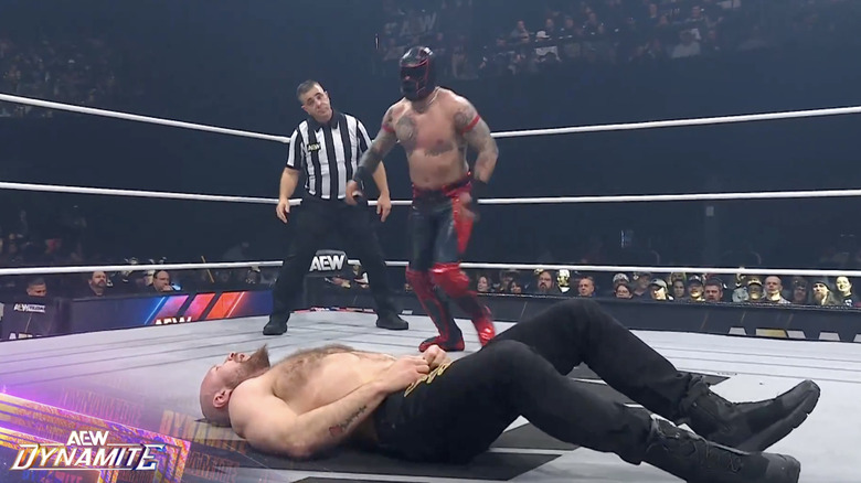 Clon standing over Moxley