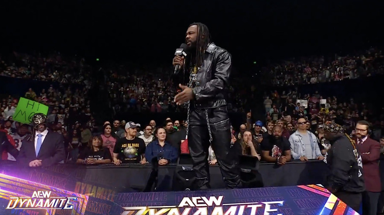 Strickland standing on top of the commentary desk talking