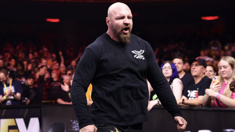 Moxley in front of a barricade