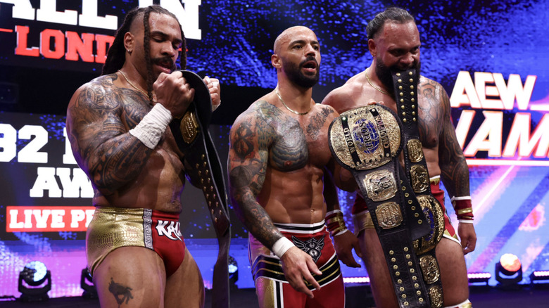 The Demand on the entrance ramp with their World Trios Championship belts