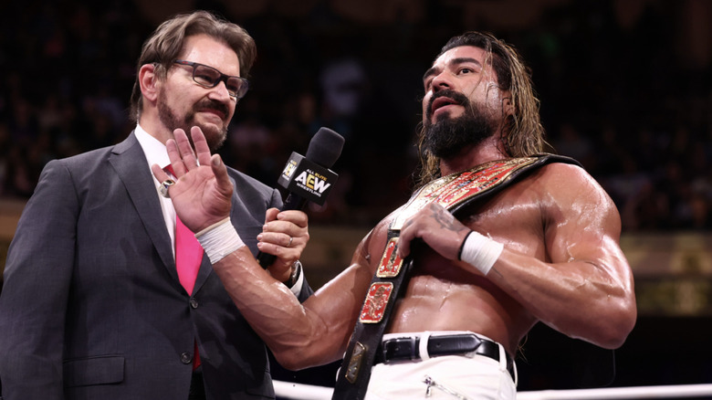 Andrade talking to Tony Schiavone inside the ring