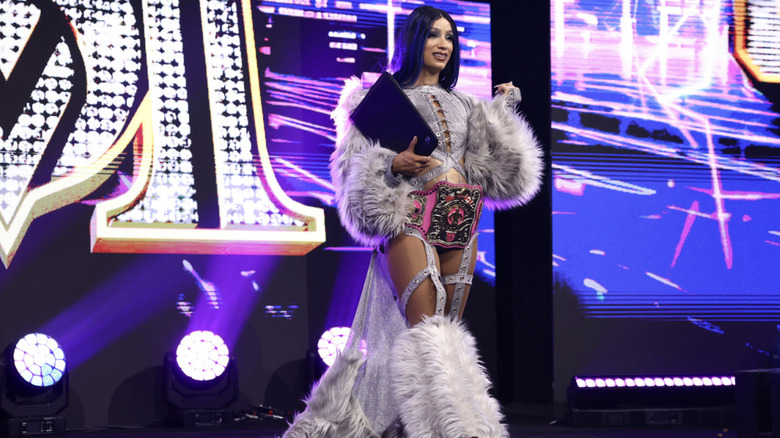 Mone on the entrance ramp with a contract in hand