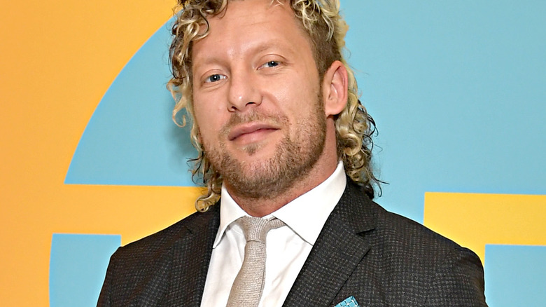 Kenny Omega poses at a promotional event 