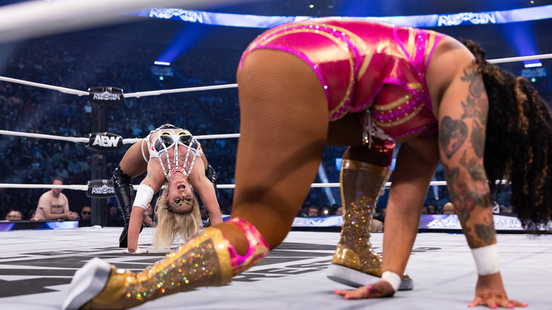 Thekla hits her spider pose, taunting a downed Willow Nightingale in the ring, during their match for the AEW Women's World Championship at AEW Redemption.