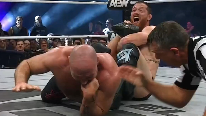 Kyle O'Reilly holds Jon Moxley in an ankle lock