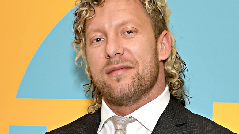 Kenny Omega smiles at a promotional event 