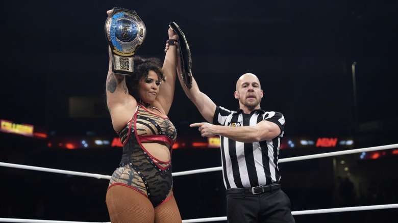 Nightingale in the ring holding up the TBS Championship