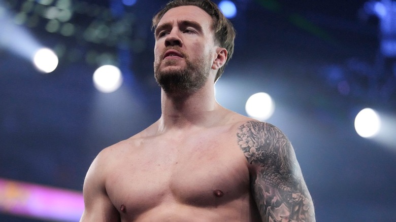 Will Ospreay stands in the ring
