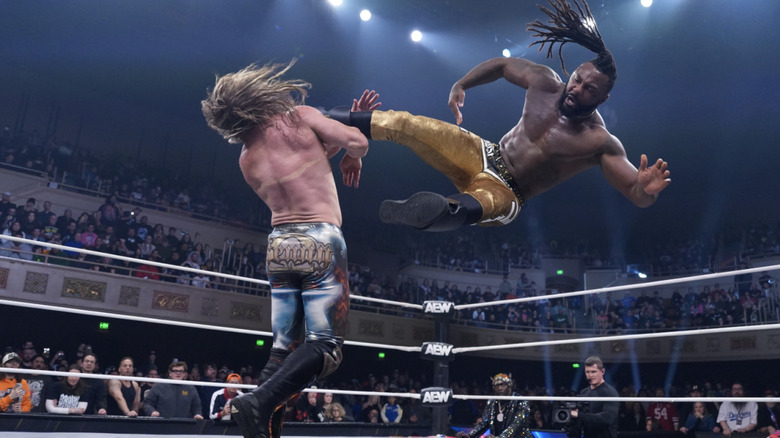 Strickland about to land a dropkick on Omega