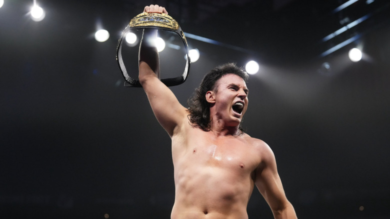 Speedball holding up his World Trios Championship