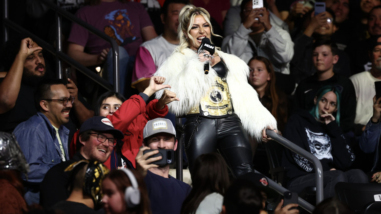 Thekla in the crowd with her AEW Women's World Championship belt