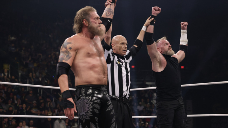 The referee raising Copeland & Cage's arms