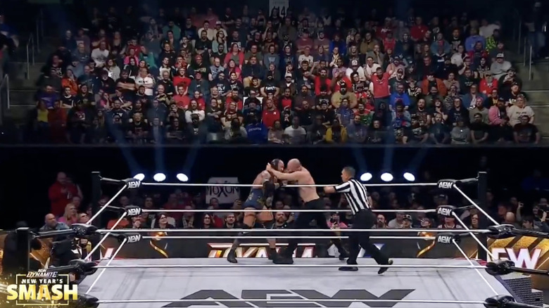 Alexander and Moxley brawling on the ring apron