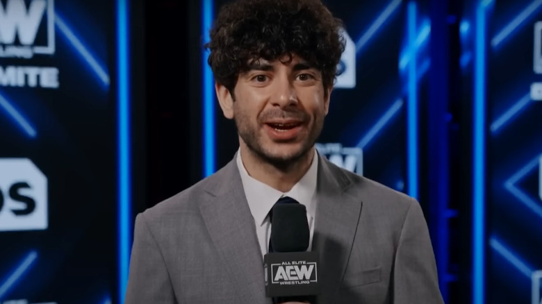 Tony Khan talking into a microphone