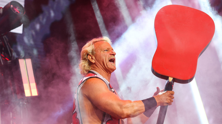 Jeff Jarrett holding up a guitar