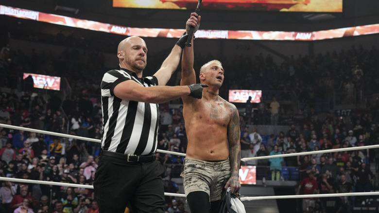 A referee holding up Allin's hand