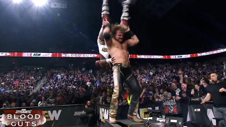 Page landing a back body drop on Hobbs