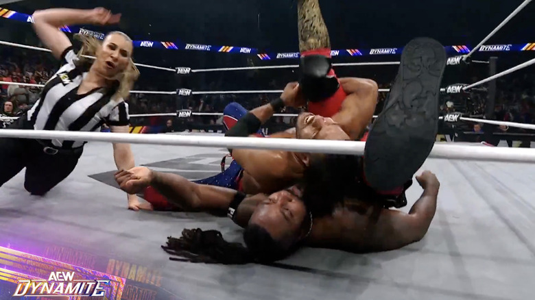 Knight pinning Strickland as Strickland has his foot on the bottom rope