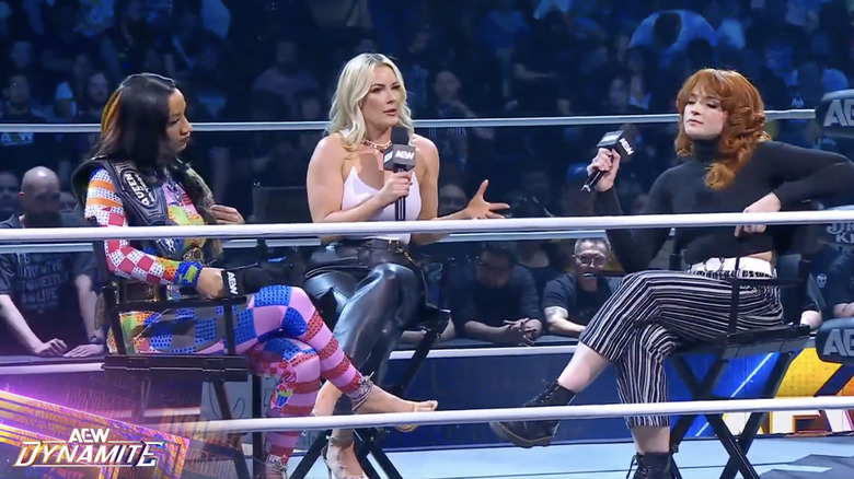 Mone and Hayter speaking in the ring as Paquette monitors