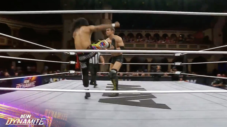 Okada catching a boot from Quintero