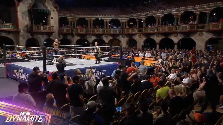 Castagnoli staring at Allin in the crowd as Briscoe lays down in the ring