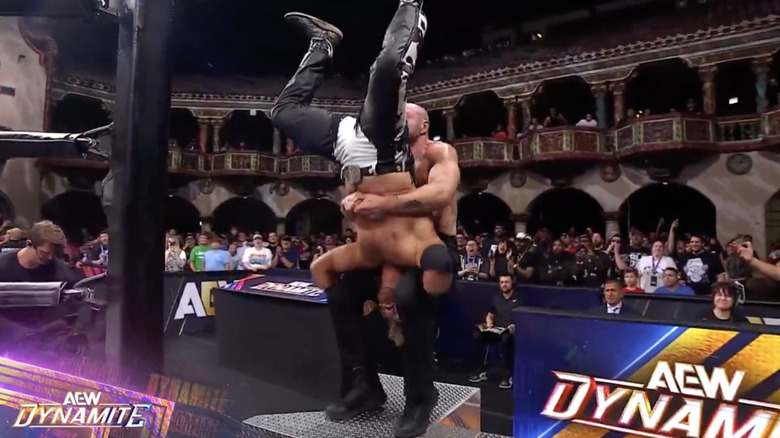 Moxley landing a piledriver on Page on top of the ring steps