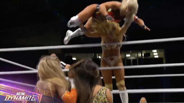 Bayne throwing Thekla on top of Bayne and Melo on the outside