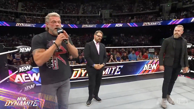 Copeland and Cage in the ring with Schiavone standing between them