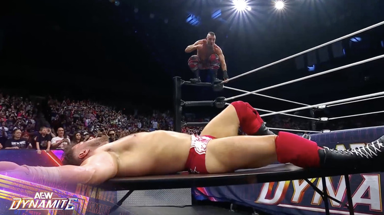 Mark about to fly and send MJF crashing through the table on the outside