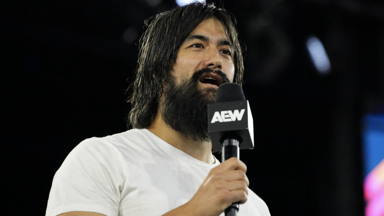 Yuta in the ring speaking on the microphone