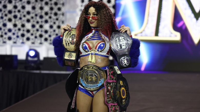 Mone on the entrance ramp with all of her titles