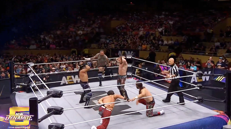 Everyone in the ring as Omega and Bandido do the macarena