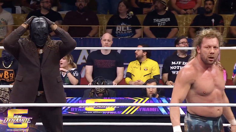 Andrade standing behind Omega