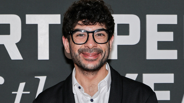 Tony Khan wearing glasses