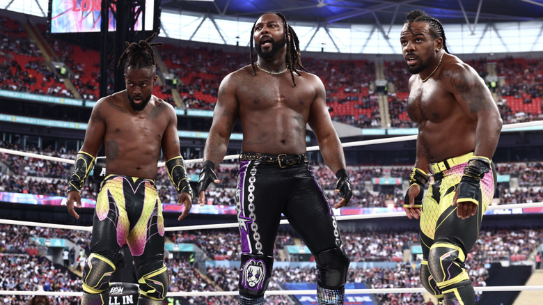 Kofi, Strickland, and Creed all inside the ring