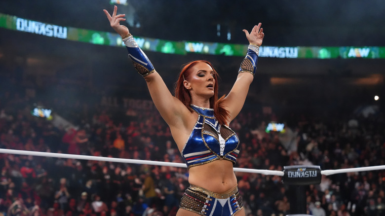 Kamille poses in the ring after winning her return match at AEW Dynasty.