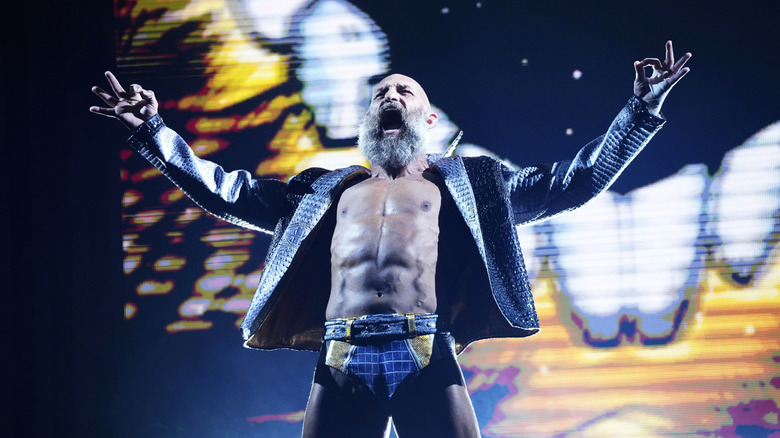 Tommaso Ciampa poses on the stage before heading down the ramp to the ring during AEW Dynasty.