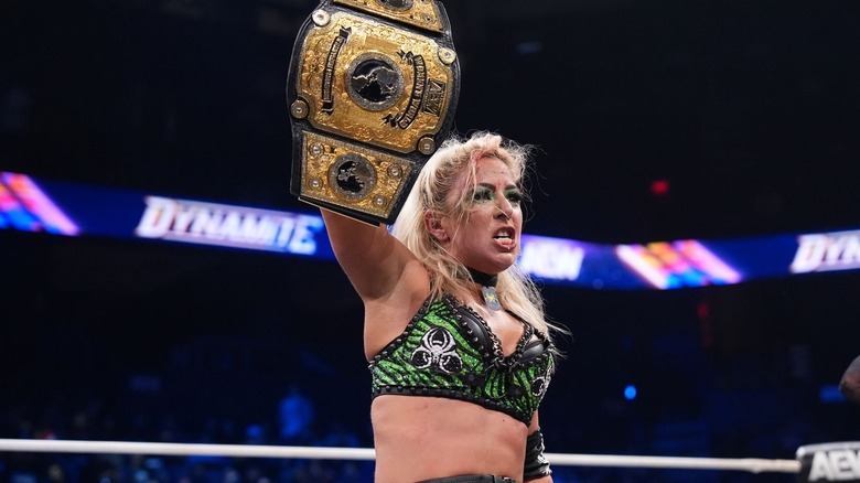 Thekla holding up the title