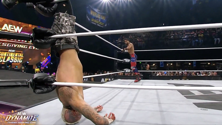 Allin draped off the top rope by his knees