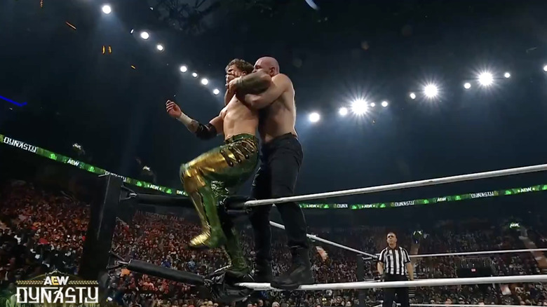 Ospreay and Moxley teetering on the ropes