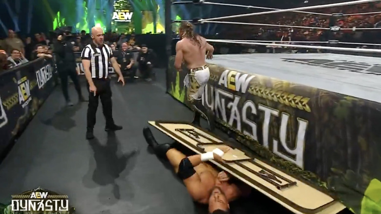 MJF with the table on top of him that Omega had placed