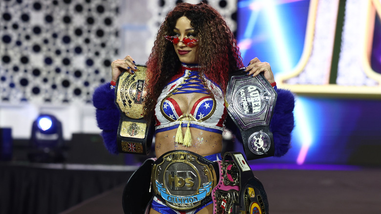 Mercedes Moné carrying her championships
